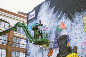 man painting mural
